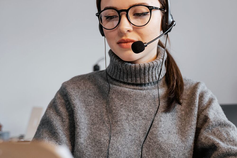 Conseillère avec casque téléphonique à son poste de travail